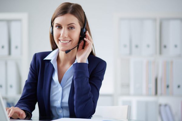 Young businesswoman with headset working in office
