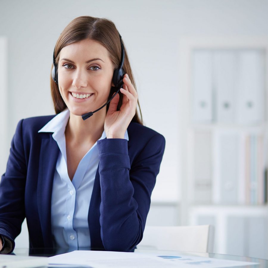 Young businesswoman with headset working in office